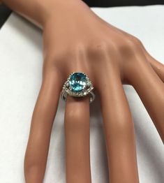 7.80 Carats Natural Very Nice Looking Blue Zircon and Diamond 14K Solid White Gold Ring Suggested Replacement Value: $6,500.00 Total Natural Oval Cut Blue Zircon Weight is: 7.00 Carats Natural Round Diamonds Weight: .80 Carats (color G-H / Clarity SI1-SI2) Ring total weight: 6.1 grams Disclaimer: all weights, measurements and colors are approximate and may vary slightly from the listed dimensions or as seen in the image. All pictures are magnified to show the smallest of details. Please, refer t Blue Topaz Ring In 14k White Gold, Luxury Blue Diamond Ring With Accents, Luxury Sapphire Topaz Promise Ring, Exquisite Blue Topaz Jewelry, Exquisite Blue Topaz Jewelry In Blue, Blue Cubic Zirconia Rings With Diamond Accents, Formal Aquamarine Diamond Ring With Brilliant Cut, Aquamarine Brilliant Cut Diamond Ring For Formal Occasions, Fine Jewelry With Blue Topaz And Vs Clarity