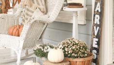 pumpkins and gourds are sitting on the front porch for fall decorating