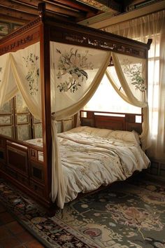 a four poster bed with white drapes over it's headboard and foot board