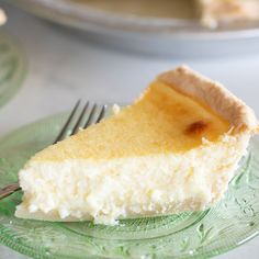 a slice of cheesecake on a green plate with a fork next to the pie