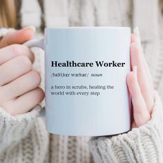 a woman holding a white coffee mug with the words healthcare worker on it in black