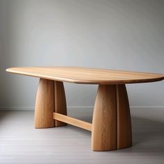 an oval wooden table with two legs on the top and one leg raised up to the floor