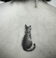 a cat tattoo on the back of a woman's neck