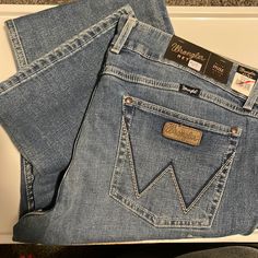 Wrangler Retro Bootcut -Mae Mid-Rise -19x34 Western Style Blue Jeans For Rodeo, Western Style Light Wash Denim Jeans, Light Wash Denim Jeans For Rodeo, Western Jeans Womens, Wrangler Bootcut Jeans, Wrangler Jeans Women's, Riding Jeans, Western Wear Outfits, Dark Wash Bootcut Jeans