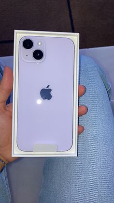 a person holding an iphone in their left hand with the box open and it's inside