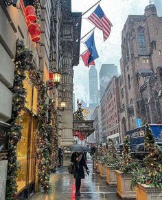 people walking down the street with umbrellas in the rain