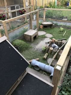 an outdoor area with grass, rocks and wooden posts in the background is a small garden