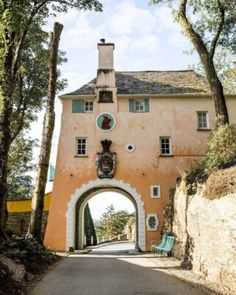 an archway leading to a building with a clock on it