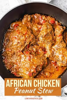 the african chicken is cooked in a skillet with red peppers and sauce on top