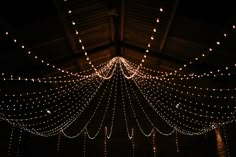 the lights are hanging from the ceiling in the room with it's long drapes