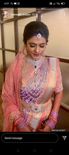 a woman in a pink sari with jewelry on her neck and chest, posing for the camera