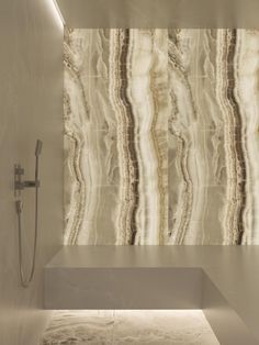 a modern bathroom with marble walls and flooring