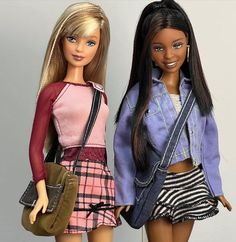 two barbie dolls standing next to each other holding purses and looking at the camera