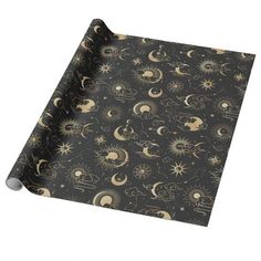 a black wrapping paper with gold sun and moon designs