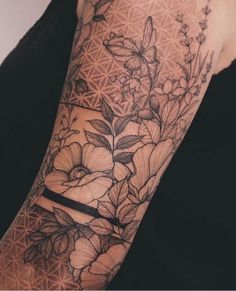 a woman's arm with flowers on it