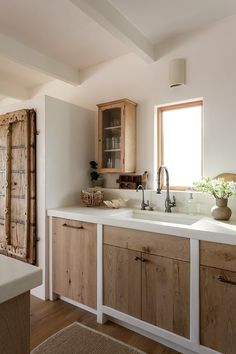 a kitchen with wooden cabinets and white counter tops