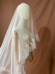 a mannequin wearing a white wedding veil