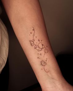 a woman's arm with a small tattoo on it