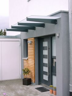 an entrance to a house with a potted plant