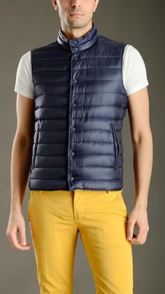 Blue waterproof ultralight quilted waistcoat featuring a stand up collar, horizontal stitch detailing, full lenght snap button fastening, two zippered side pockets, green reverse with two buttoned side pockets, 95% goose down, 5% feather down padding. Quilted Waistcoat, Herno Jacket, Stand Up Collar, Snap Button, Stand Up, Blue Green, Zipper, Collar, Green