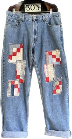 a pair of jeans with patches and numbers on them