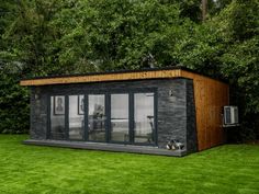 a small building sitting on top of a lush green field