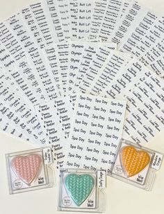 six heart shaped stickers with words on them in different colors and sizes, sitting next to each other