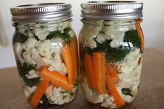 two mason jars filled with carrots and cauliflower