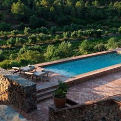 an outdoor swimming pool surrounded by stone steps