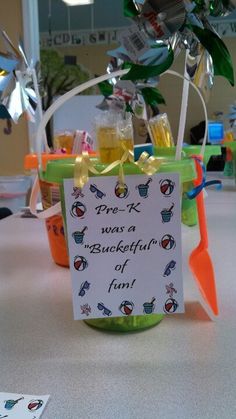 a bottle filled with drinks sitting on top of a table next to a sign that says free k was a bucket of fun