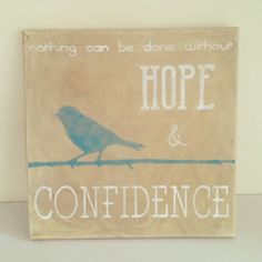 a wooden sign that says hope and confuence with a blue bird on it