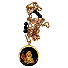 Introducing a handcrafted, one-of-a-kind necklace that combines vintage charm with artistic flair. This striking piece features a truly unique vintage locket pendant, showcasing an exquisite black onyx backing. The locket is adorned with a mesmerizing gold leaf design depicting a long-haired goddess with a giant moon and twinkling stars, capturing the essence of celestial beauty. Measuring 1.5 inches, the pendant is elegantly suspended on a vintage brass chain, which is embellished with black on Hourglass Pendant, Gold Leaf Design, Vintage Locket, Mountain Necklace, Twinkling Stars, Vintage Lockets, White Gold Necklaces, Modern Necklaces, Handcrafted Necklace