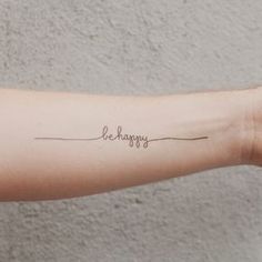 a woman's arm with the word happy written on it in cursive writing