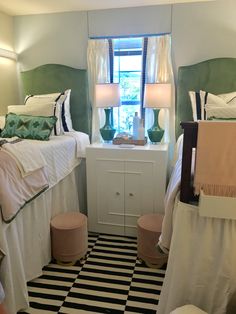 two twin beds in a small room with black and white checkered flooring