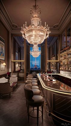 an elegant bar with chandelier and chairs