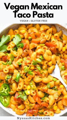 vegan mexican taco pasta in a white bowl with a spoon and cilantro on the side