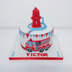 a red and white cake with a fire hydrant on top