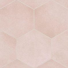 a pink tile wall with hexagonal shapes