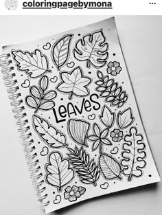 a notebook with leaves on it and the words leaves written in black ink next to an open spiral notebook