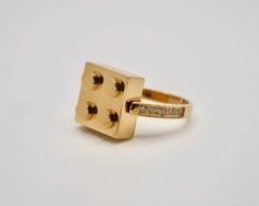 Introducing our Lego-inspired block ring, a playful twist on classic elegance! Crafted with care and plated in 18K yellow gold, this ring adds a touch of fun to any ensemble. Two sparkling cubic zirconia stones adorn each side of the band, catching the light with every movement. Whether you're building your jewelry collection or adding a pop of personality to your look, this ring is sure to spark joy.  Item Details * Ready to Ship * Gold Kt: 18K Plated Gold If you have any additional questions about this ring, just hit the "Ask a Question" button (just to the right of the price) and we will get back to you within a few hours. Be sure to hit "favorite" on the right so it remains in your favorites list and/ or add to your wish list(s). Thank you for taking the time to look at my shop. I hope Lego Ring, Things A Girl Needs, Lego Jewelry, Rings Pretty, Spark Joy, Shiny Things, 10k Gold, Rings Statement, Classic Elegance