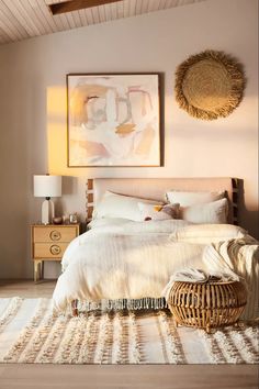 a bedroom with a large bed and wicker basket on the floor next to it