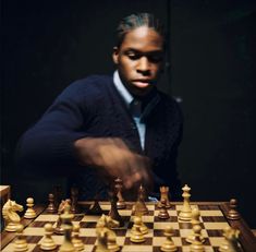 a man is playing chess with his hand on the board