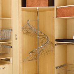 a closet with shelves and wire baskets on the bottom, along with other items in it