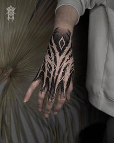 a person's hand with black and white designs on it