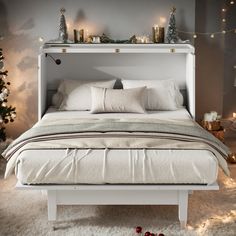 a white bed with christmas decorations on the headboard and foot board in front of it