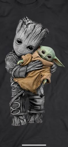 an image of baby yoda holding the child in his arms