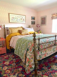 a bed room with a neatly made bed and colorful rugs on the floor next to it