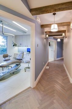 an empty dental office hallway leading to the dentist's chair