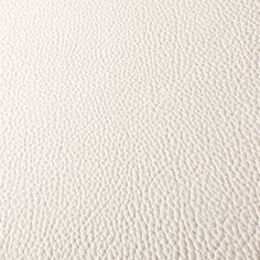 an up close view of white leather textured with natural grains on the surface