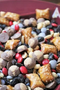 a red bowl filled with nuts and candy